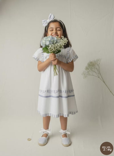 Santorini organic cotton flutter-sleeve girls dress video showing breezy movement and fabric drape